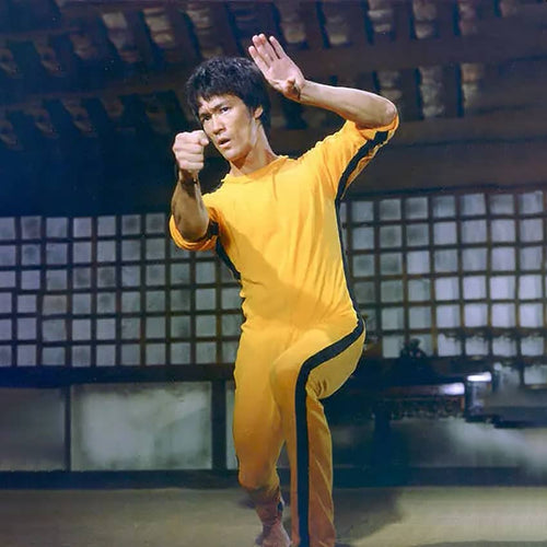 Bruce Lee wearing yellow jumpsuit in the movie Game of Death