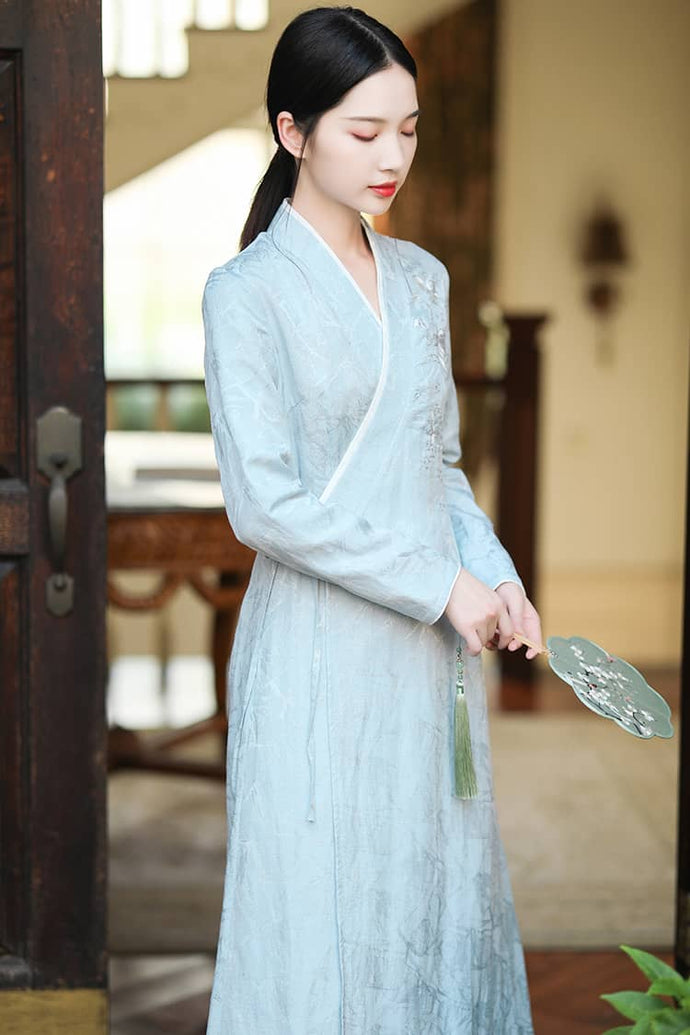 A woman with a blue embroidered modern hanfu dress with jacquard fabric